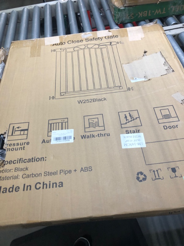 Photo 1 of Black auto close safety gate 54.33-57.08 inches