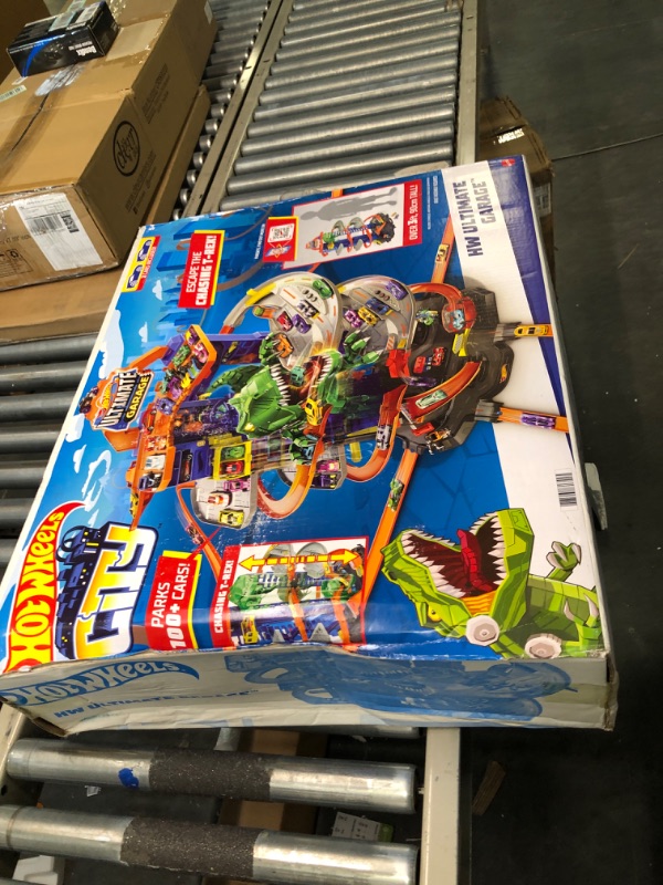 Photo 1 of Hot Wheels Track Set, Ultimate Garage Toy Vehicle Playset With Moving T-Rex Dinosaur, Storage For 100+ Vehicles, 3ft+ Tall