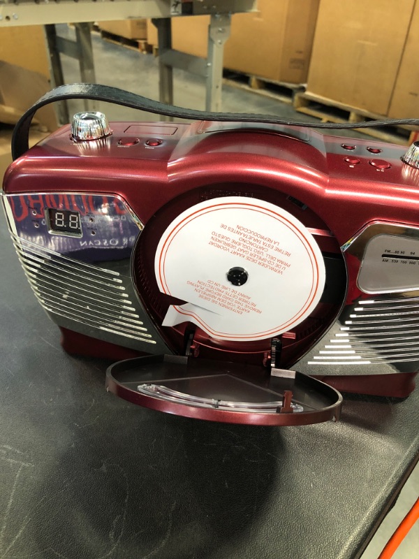 Photo 3 of PROSCAN Retro Style Portable CD Boombox with AM/FM Radio- Top Loading CD - Aux-in Jack - AC & Battery Compatible - LCD Display - Carrying Handle RED