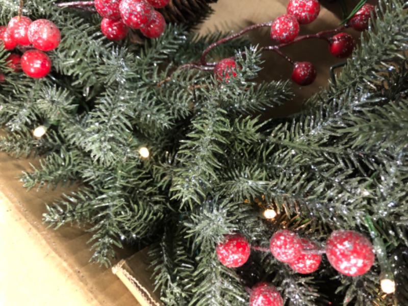 Photo 1 of National Tree Company Pre-Lit Artificial Christmas Wreath, Green, Crestwood Spruce, White Lights, Decorated with Pine Cones, Berry Clusters, Christmas Collection, 24 Inches 24 in Plug In