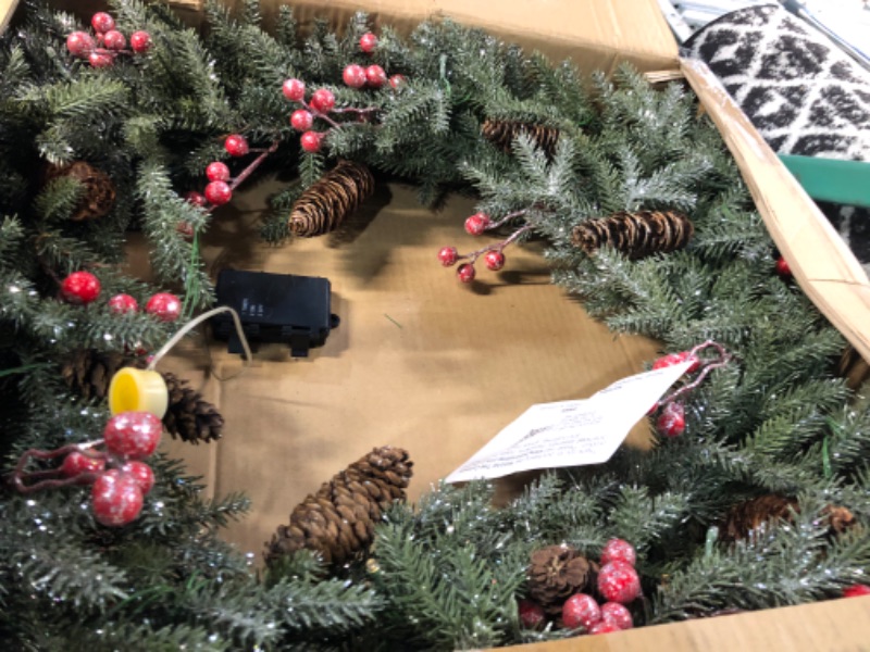 Photo 1 of National Tree Company Pre-Lit Artificial Christmas Wreath, Green, Crestwood Spruce, White Lights, Decorated with Pine Cones, Berry Clusters, Christmas Collection, 24 Inches 24 in Plug In