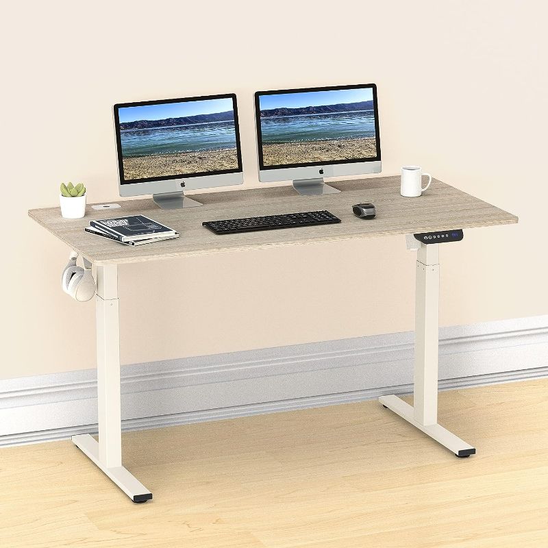 Photo 1 of SHW 55-Inch Large Electric Height Adjustable Standing Desk, 55 x 28 Inches, Maple
