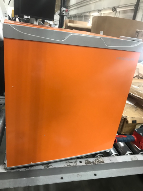 Photo 2 of * not functional * sold for parts * damaged *
 Frigidaire EFR115-ORANGE 1.6 Cu Ft Compact Fridge, Orange