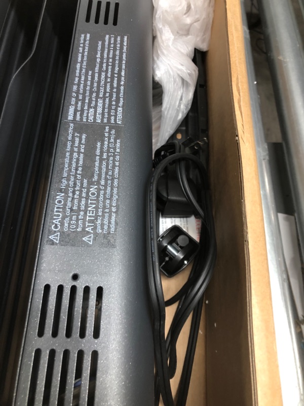 Photo 1 of Amazon Basics Portable Radiator Heater with 7 Wavy Fins, Manual Control, Black, 1500W, 13.1 x 26.3 x 9.8 in