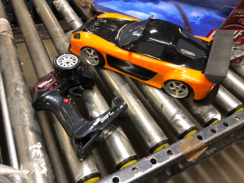 Photo 2 of Jada Toys Fast & Furious Han’s Mazda RX-7 Drift RC Car, 1: 10 Scale 2.4Ghz Remote Control Orange & Black, Ready to Run, USB Charging (Standard) (99700)