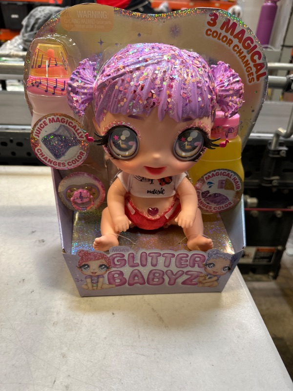 Photo 2 of MGA Entertainment Glitter Babyz Melody Highnote Baby Doll with 3 Magical Color Changes, Lavender Glitter Hair, Music Outfit, Diaper, Bottle, Pacifier Accessories, Ages 3 4 5+