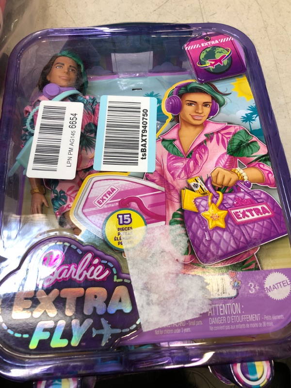 Photo 1 of Barbie Extra Fly Ken Doll with Beach-Themed Travel Clothes & Accessories, Tropical Outfit with Boogie Board & Duffel Bag