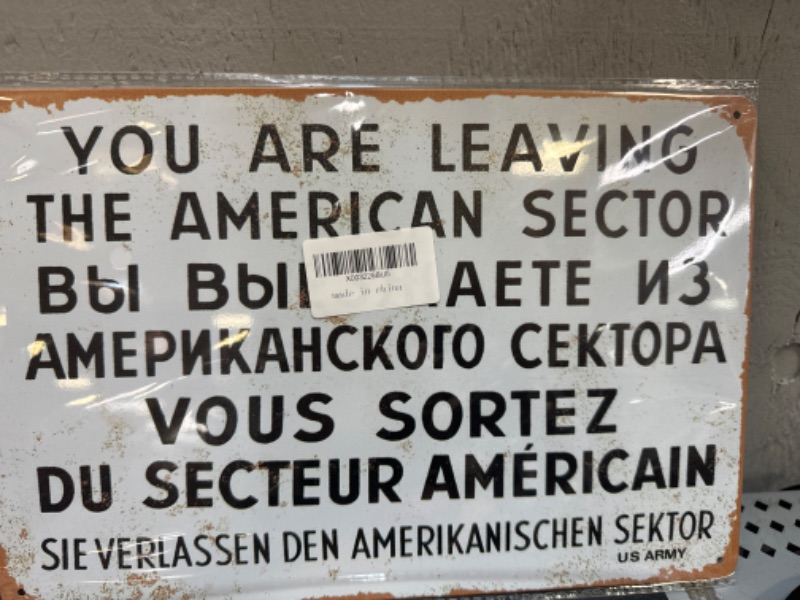 Photo 1 of A sign with text in English, Russian and French, dating from the days of the Cold War.