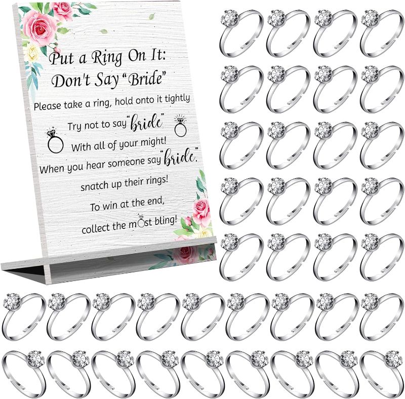 Photo 1 of Put a Ring on It Bridal Shower Game Fake Wedding Rings Metal Adjustable Engagement Rings Rustic Greenery Theme Not Say Bride Rules Wooden Sign Bridal Shower Gifts for Guests(Silver)