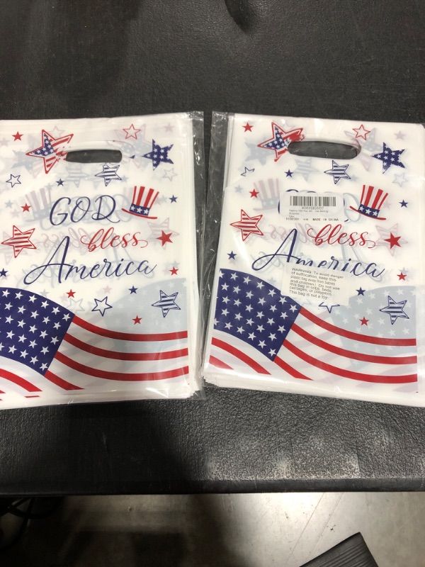 Photo 2 of ( 2 pack) Pasimy 100 Pcs 4th of July Plastic Candy Bag Independence Day Plastic Candy Favor Bag with Handle, 7 x 9"