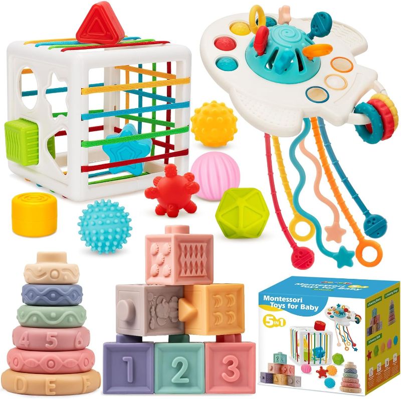 Photo 1 of Baby Toys 6 to 12 Months, 5 In 1 Montessori Toys for 1 Year Old, Incl Travel Pull String Toy & Shape Sorter & Stacking Baby Block & Soft Infant Ring & Sensory Ball for Toddler 0-3-6-9-12 Month
