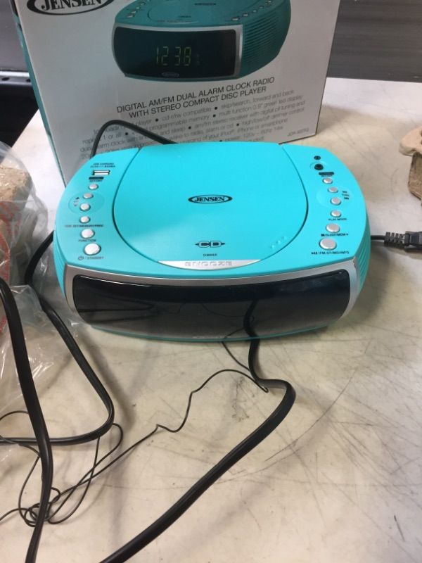 Photo 1 of Jensen Turquoise Modern Home CD Tabletop Stereo Clock Digital AM/FM Radio CD Player Dual Alarm Clock Stereo CD Top-Loading Disc Player | USB Charging Port DV 5V 800mA | Headphone Jack | 0.9 Display
UNABLE TO TEST - BATTERIES NOT INCLUDED