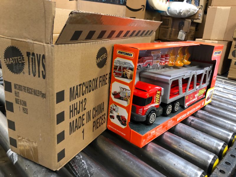 Photo 3 of ?Matchbox Fire Rescue Hauler Playset Themed Hauler with 1 Fire-Themed Vehicle, Holds 16 Cars, Easy-Release Ramp, 8 Accessories & Storage, for 3 & Up [Amazon Exclusive]
