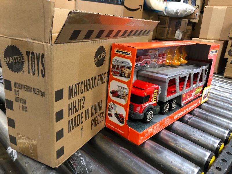 Photo 2 of ?Matchbox Fire Rescue Hauler Playset Themed Hauler with 1 Fire-Themed Vehicle, Holds 16 Cars, Easy-Release Ramp, 8 Accessories & Storage, for 3 & Up [Amazon Exclusive]