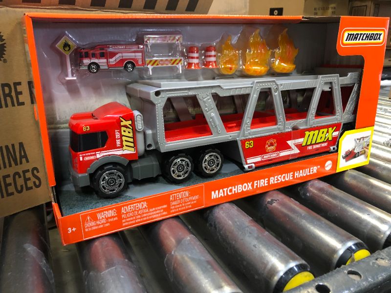 Photo 3 of ?Matchbox Fire Rescue Hauler Playset Themed Hauler with 1 Fire-Themed Vehicle, Holds 16 Cars, Easy-Release Ramp, 8 Accessories & Storage, for 3 & Up [Amazon Exclusive]