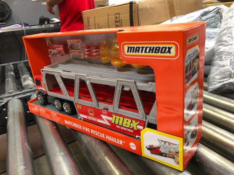 Photo 2 of ?Matchbox Fire Rescue Hauler Playset Themed Hauler with 1 Fire-Themed Vehicle, Holds 16 Cars, Easy-Release Ramp, 8 Accessories & Storage, for 3 & Up [Amazon Exclusive]