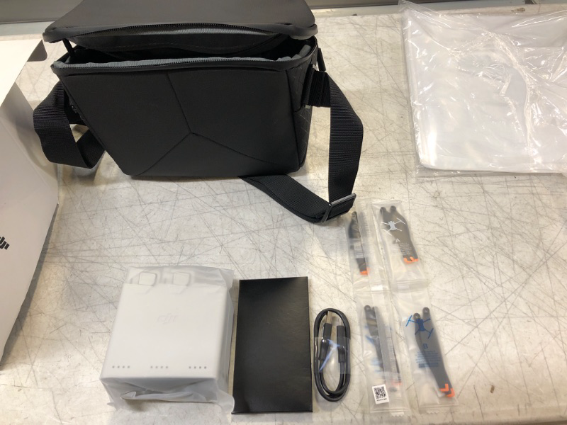 Photo 2 of DJI Mini 3 Pro Fly More Kit, Includes Two Intelligent Flight Batteries, a Two-Way Charging Hub, Data Cable, Shoulder Bag, Spare propellers, and Screws