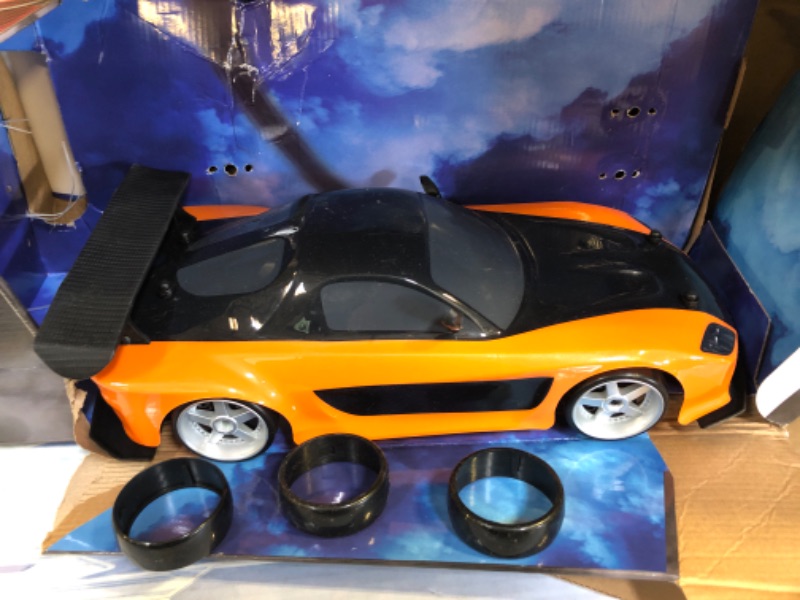 Photo 2 of Jada Toys Fast & Furious Han’s Mazda RX-7 Drift RC Car, 1: 10 Scale 2.4Ghz Remote Control Orange & Black, Ready to Run, USB Charging (Standard) (99700)