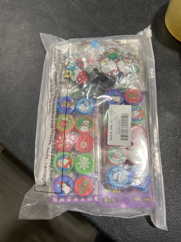 Photo 2 of 260 Pieces Christmas Stocking Stuffers Include 110 Temporary 100 Christmas Candy Bags 20 Christmas Stampers 15 Slap Bracelets 15 Keychains for Christmas Party Favors Game Reward Decor