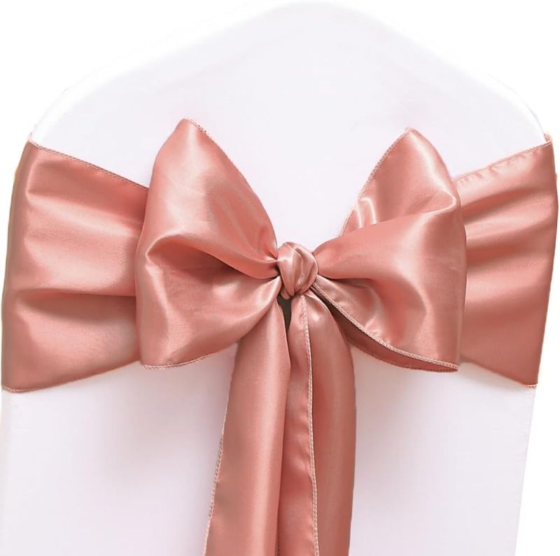 Photo 1 of 50 Pack Satin Rose Gold Chair Sashes for Wedding Gender Reveal Party Birthday Reception, Hotel Event, Banquets Chairs Decorations, Rose Gold Satin Chair Sashes Bows for Folding Chairs
