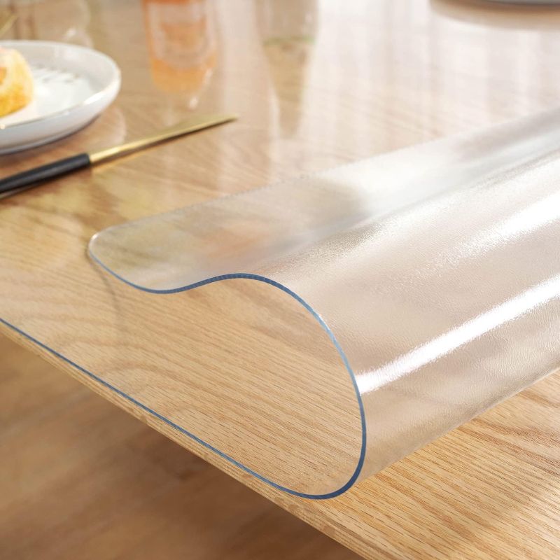 Photo 1 of Plastic Table Cover Protector, Desk Pad Mat Blotter, Waterproof PVC Desk Protector, Desk Mat on Top of Desks Transparent Desk Writing Mat