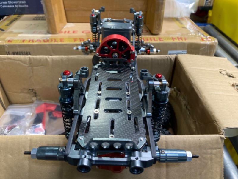Photo 1 of RC Car Frame, Metal Carbon Fiber RC Car Frame Kit 313mm RC Crawler Tires Wheelbase Set for AXIAL SCX10
