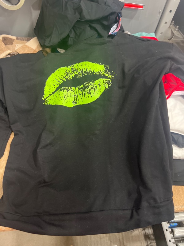 Photo 1 of black long sleeve with a green lip print on the front size XL 