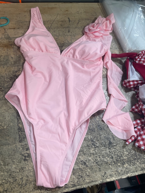 Photo 1 of 1 piece womens pink bathing suit with flower detail on shoulder  size small 