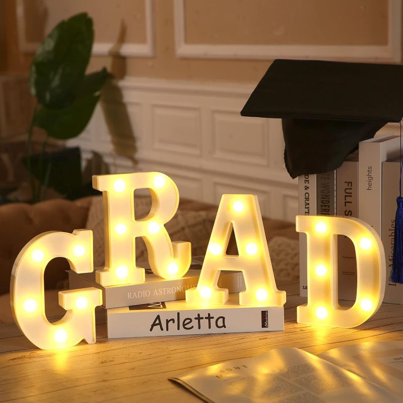 Photo 1 of Demissle 4 Graduation Party Decorations 2024 Grad LED Marquee Letters Graduation Table Light Up Sign for Kindergarten Preschool High School College Class of 2024 Graduation Party Supplies(White)
