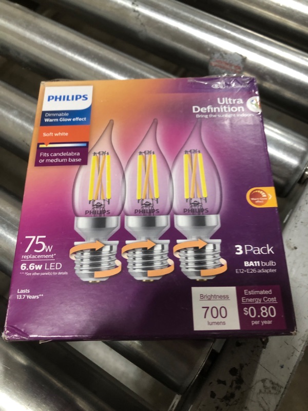 Photo 2 of Philips LED Ultra Definition Dimmable, Eye Comfort Technology, Soft White 2700K BA11, E12 Base with E26 Adapter, Clear Glass Light Bulb, 700 Lumen, 6.6W=75W, T20 Certified, 3-Pack (564492) Soft White (2700k) E12 700 Lumen