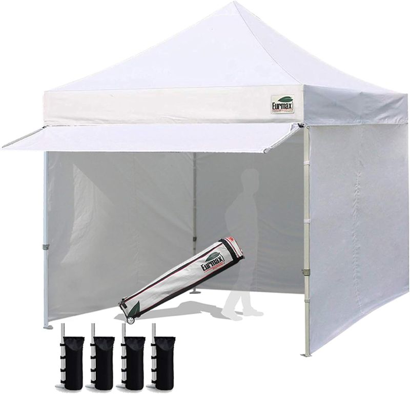 Photo 1 of ***Stock photo is a similar item**** Eurmax USA 10 x 10 Pop up Canopy Commercial Tent Outdoor Party Canopies with 4 Removable Zippered Sidewalls and Roller Bag Bonus 4 Canopy Sand Bags & 24 Squre Ft Extended Awning(White)
