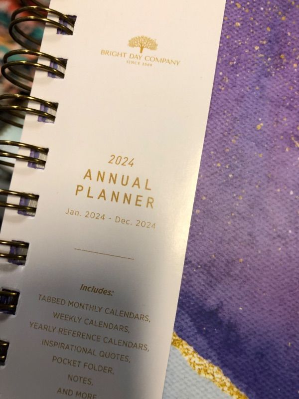 Photo 1 of 2024 Purple Annual Planner by Bright Day, Yearly Monthly Weekly Daily Spiral Bound Dated Agenda Flexible Cover Tabbed Notebook, 8.25 x 6.25