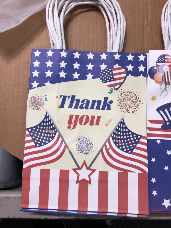 Photo 1 of 12 Pcs Patriotic Gift Bags with Handle with 24 Red Blue White Tissue Paper and Stickers, USA Flag Paper Gift Bags Party Candy Favor Bags Goodie Treat Bags for Veterans Day 4th of July Independence Day Party Supplies
