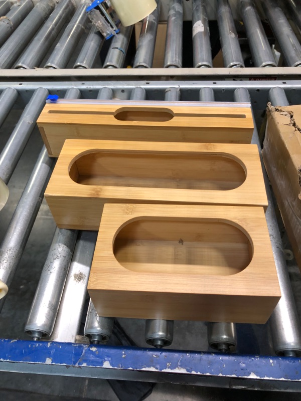 Photo 1 of GJDAMFD Foil and Plastic Wrap Dispenser with Cutter for Kitchen Drawer - 6 IN 1 Bamboo Ziplock Bag Storage Organizer for Gallon, Quart, Sandwich, Snack ***USED**CAN BE USED FOR PARTS**** 