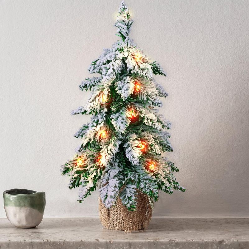 Photo 1 of Small Christmas Tree with Lights, Prelit Mini Artificial Christmas Tree for Tabletop Decorations, Snow Flocked, Battery Operated Table Xmas Tree for Bedroom, Office, Small Spaces, 20 inch
