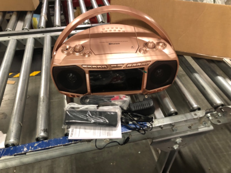 Photo 1 of Aiwa Portable Boombox, Crystal Clear Sound with 3W x 2 Speakers and Bass Function, Featuring a 7" LCD Display, Bluetooth Connectivity, FM Radio, CD/DVD Player, Streaming on Roku and Amazon Firestick Rose Gold