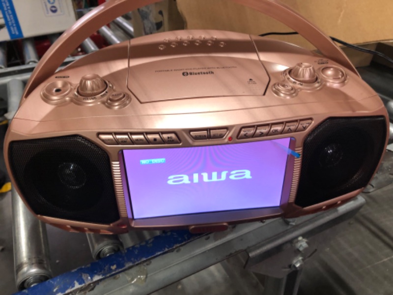 Photo 1 of Aiwa Portable Boombox, Crystal Clear Sound with 3W x 2 Speakers and Bass Function, Featuring a 7" LCD Display, Bluetooth Connectivity, FM Radio, CD/DVD Player, Streaming on Roku and Amazon Firestick Rose Gold