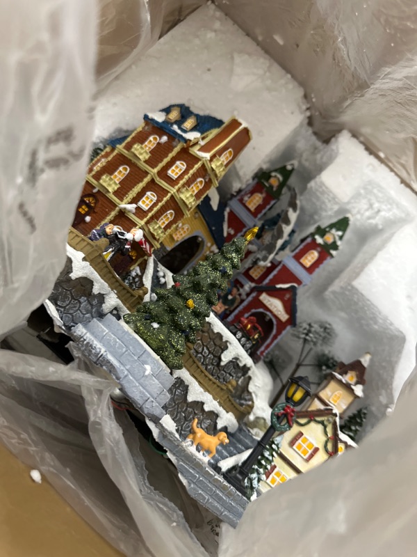 Photo 2 of Teabelle Large Christmas Village House Musical Decoration with Rotating Christmas Tree and Train, Colorful Light Village Center Tower Buildings, Xmas Village Music Box New Year's Gift for Children