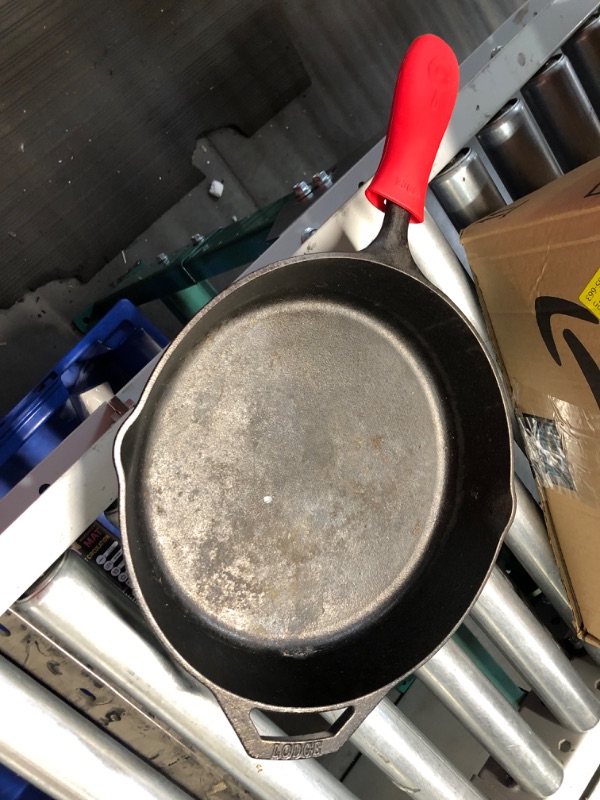 Photo 4 of ***USED AND DIRTY***
Lodge Cast Iron Skillet with Red Silicone Hot Handle Holder, 12-inch