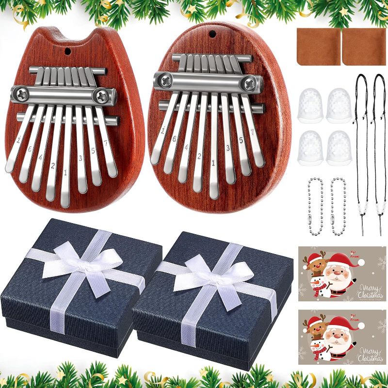 Photo 1 of 16 Pcs 8 Keys Mini Kalimba Piano Set, Include Mini Finger Thumb Piano with Gift Box, Christmas Card, Lanyard Chain, Finger Protector and Cleaning Cloth for Kids and Adult Beginners Gift (Red, White)