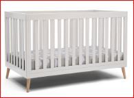 Photo 1 of Delta Children Essex 4-in-1 Convertible Baby Crib, Bianca White with Natural Legs + Simmons Kids Quiet Nights Dual Sided Crib and Toddler Mattress (Bundle)