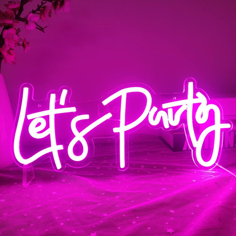 Photo 1 of Ajoyferris Let's Party Neon Signs Neon Light Sign for Wall Decor 16''x 7'' Word LED Neon Sign Art Decorative Lights for Bachelorette Party, Engagement Party, Birthday Party,Wedding Party Pink