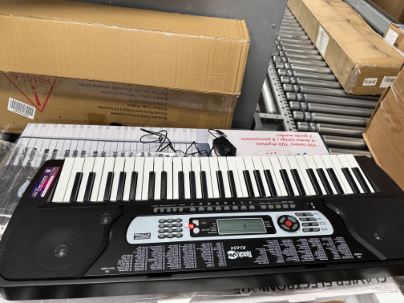 Photo 2 of **SEE NOTES**RockJam 54-Key Portable Electronic Keyboard with Interactive LCD Screen & Includes Piano Maestro Teaching App with 30 Songs & Adjustable Keyboard Stand with Locking Straps & Quick Release Mechanism