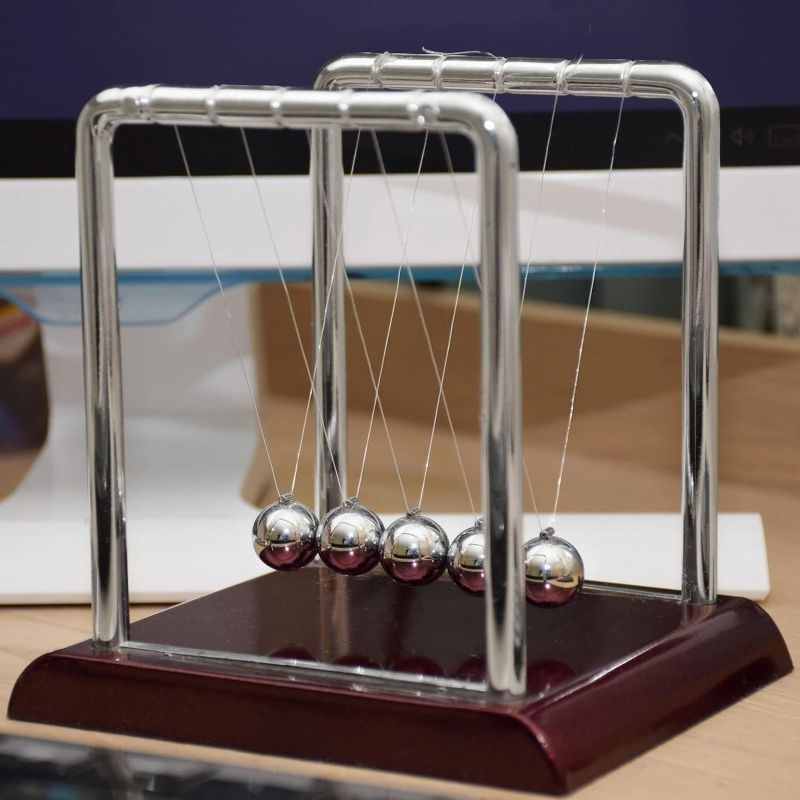 Photo 2 of Juvale Newton's Cradle Balance Pendulum, Physics Learning Desk Toy, Swinging Kinetic Balls for Home, Office Decoration, Stress Relief, Fun Science Fidget Accessories (7x6x7 in)
