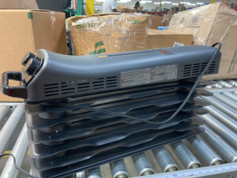 Photo 1 of Amazon Basics Portable Radiator Heater with 7 Wavy Fins, Manual Control, Black, 1500W, 13.1 x 26.3 x 9.8 in Black 13.1 x 26.3 x 9.8 in