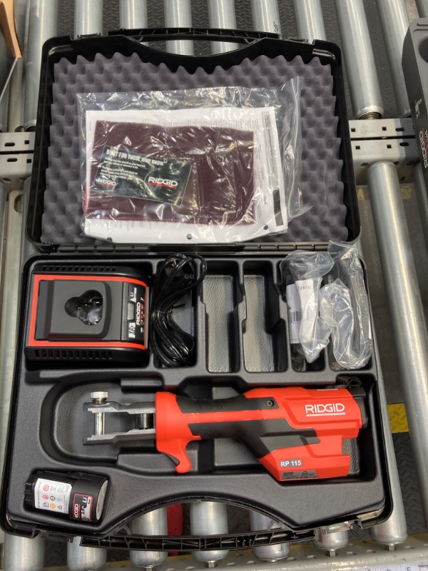 Photo 1 of ***MISSING JAWS*** aRIDGID 72553 Model RP 115 Mini Press Tool and Battery Kit with 1/2" to 3/4" ProPress Press Tool Jaws, 2V Li/Ion Battery, 12V Charger, and Carrying Case , Red