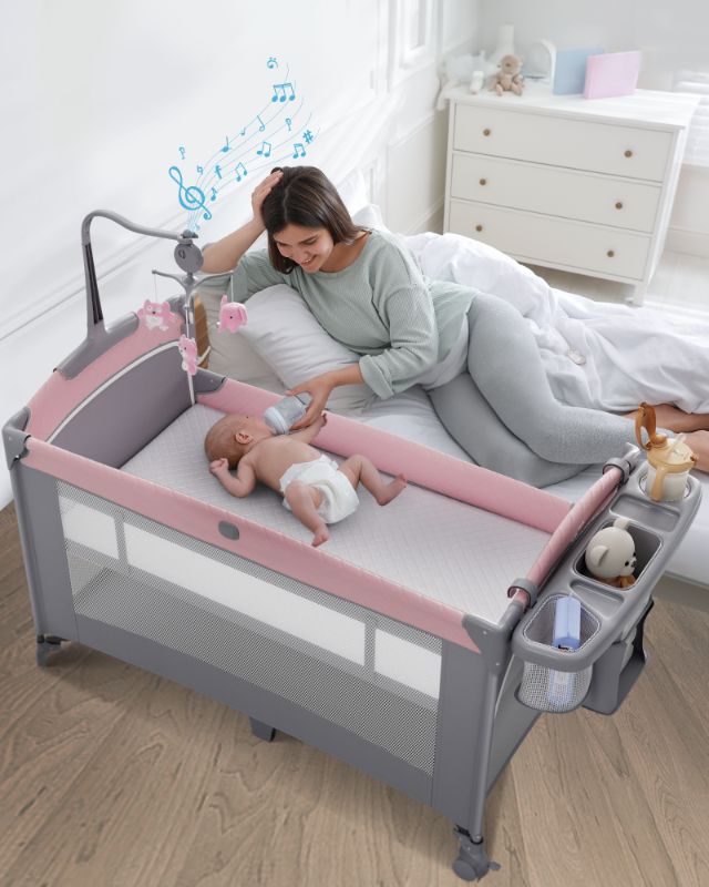 Photo 1 of 5 in 1 Baby Bassinet Bedside Sleeper, Rocking Bassinet for Baby, Easy Folding Portable Playards, Pack and Play with Mattress, Diaper Changer and Music Mobile Pink
