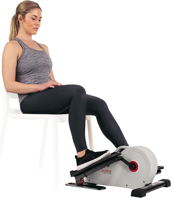 Photo 1 of Sunny Health & Fitness Sitting Under Desk Elliptical Peddler, Portable Foot & Leg Pedal Exerciser for Home or Work w Optional Magnetic, Electric Motorized, Connected or in Pink