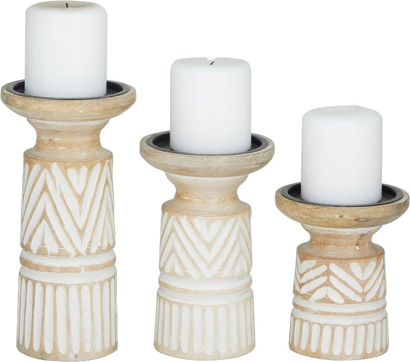 Photo 1 of Deco 79 Mango Wood Carved Tribal Pillar Candle Holder, Set of 3 10", 8", 6" H, Light Brown
