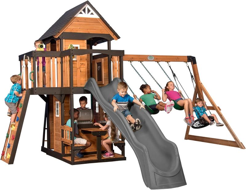 Photo 1 of Backyard Discovery Canyon Creek All Cedar Wood Swing Set w/Grey Wave Slide, Playhouse w/Grill, Plastic Food, Picnic Area, Steering Wheel, Two Belt Swings, Rock Climbing Wall, Balcony, Deck, Web Swing
